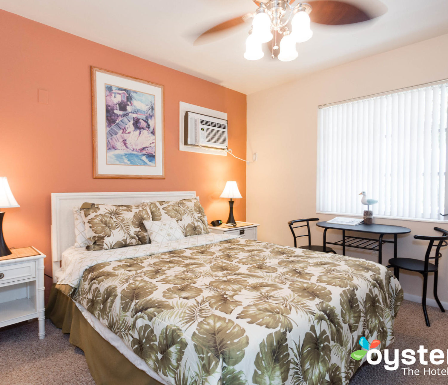 Hideaway Hotel - economy room table near window and bed