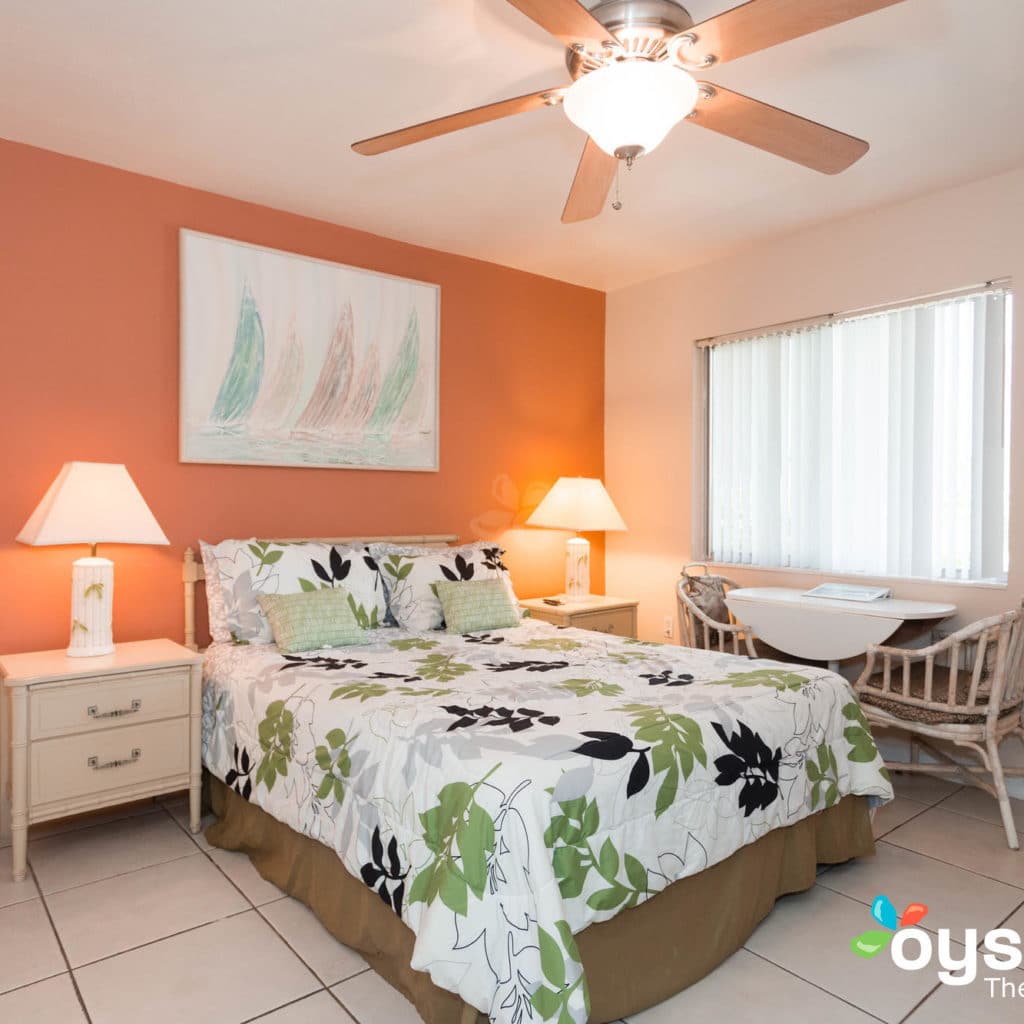 Hideaway Hotel - guest room bed and window view with seating