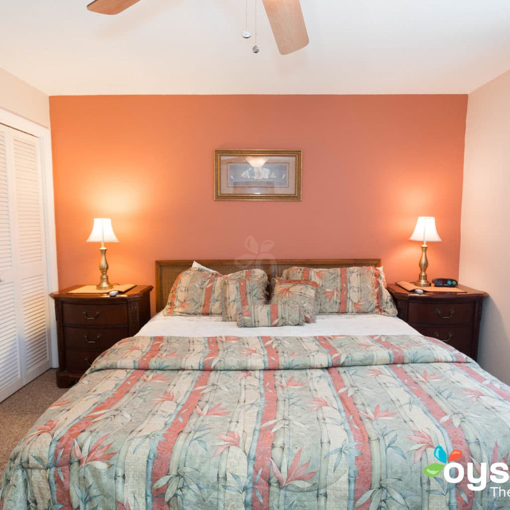 Hideaway Hotel - king suite bed and tables, lamps turned on