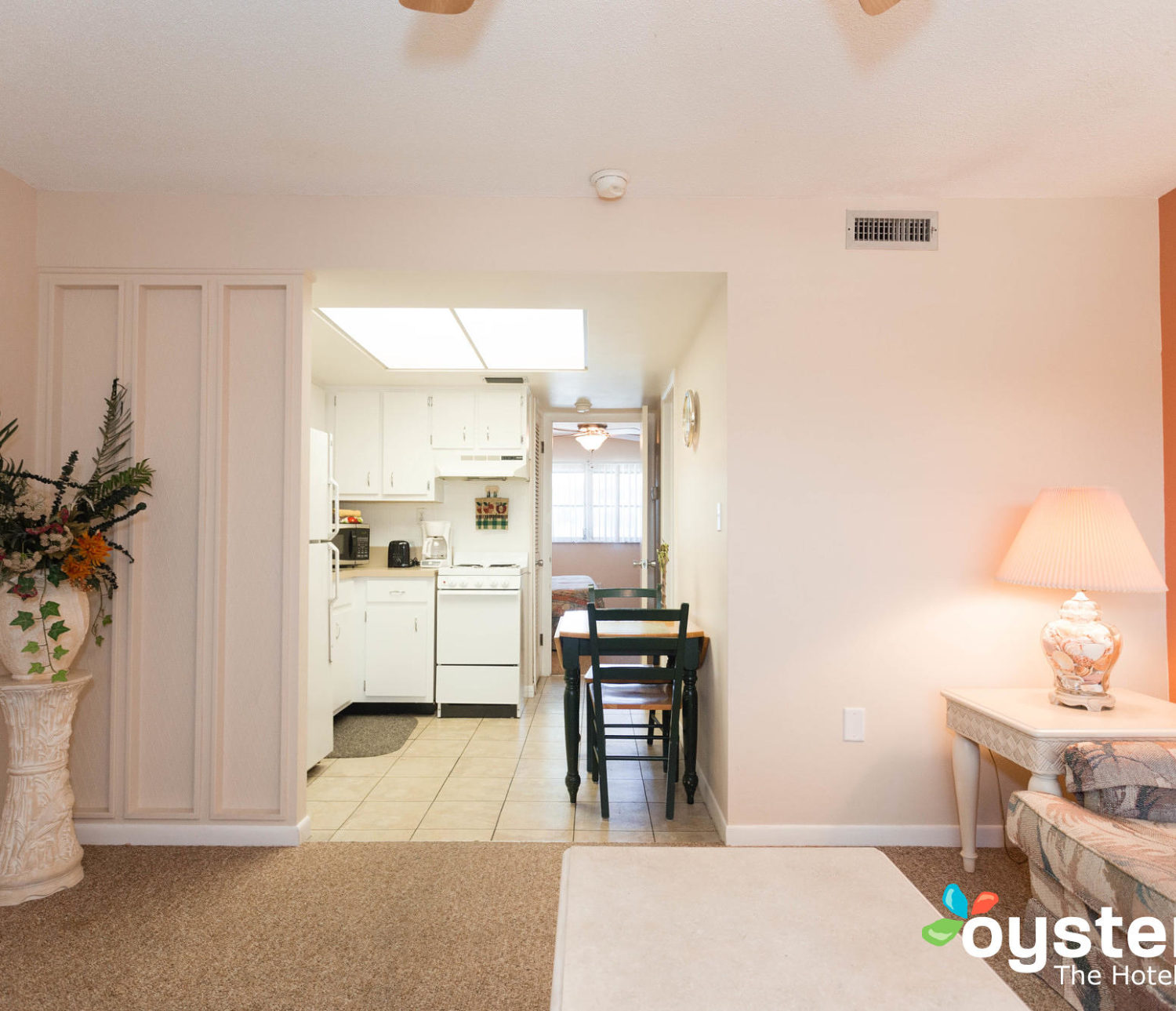 Hideaway Hotel - king suite view through living room into kitchen area and bedroom beyond, well lit and bright